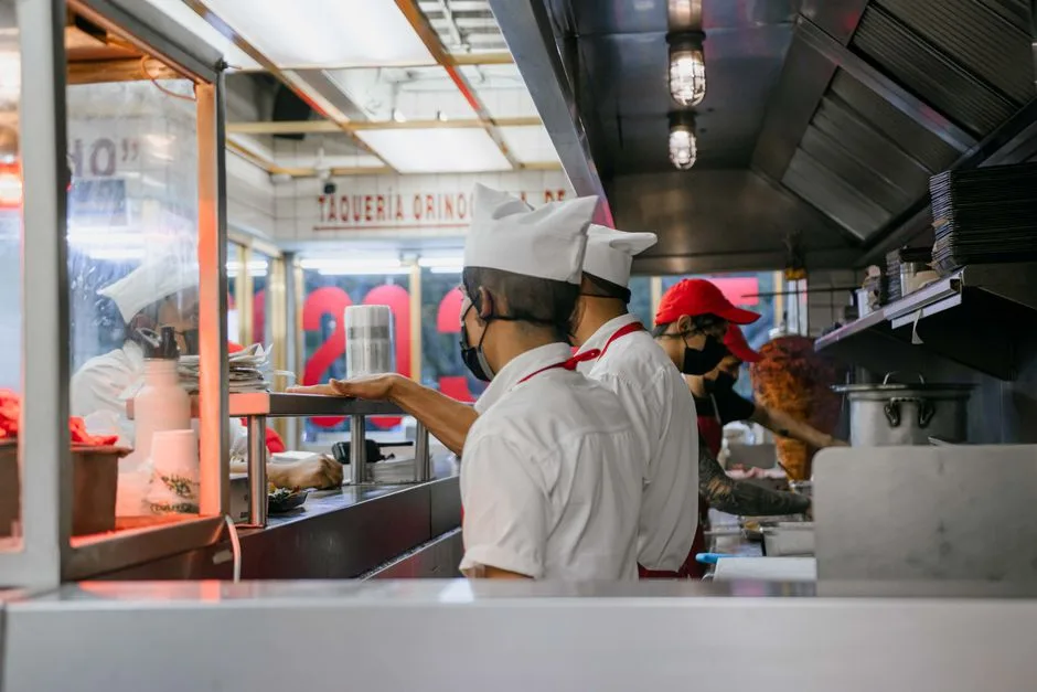 Busy commercial kitchen in Egg Harbor Township restaurant — grease-laden air rising above the cooking line into exhaust hood